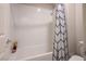 Bright bathroom featuring a tub and shower combination with a stylish black and white shower curtain at 9871 Magnus Ct, Las Vegas, NV 89178
