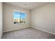 Bright bedroom featuring a large window with neighborhood views, offering a comfortable and serene living space at 9871 Magnus Ct, Las Vegas, NV 89178