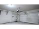 Spacious garage featuring an automatic door opener and wall-mounted pull-up bar at 9871 Magnus Ct, Las Vegas, NV 89178