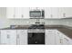 Close-up of a modern kitchen featuring stainless steel appliances and granite countertops at 9871 Magnus Ct, Las Vegas, NV 89178