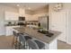 Modern kitchen featuring an island with bar seating, stainless steel appliances, and granite countertops at 9871 Magnus Ct, Las Vegas, NV 89178