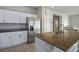 Modern kitchen with granite countertops, stainless steel appliances, and white cabinets at 9871 Magnus Ct, Las Vegas, NV 89178