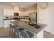 Modern kitchen with white cabinetry, granite countertops, stainless steel appliances, and kitchen island with bar stool seating at 9871 Magnus Ct, Las Vegas, NV 89178