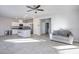 Bright, open living area featuring tile flooring, modern lighting, and a seamless flow into the kitchen at 9871 Magnus Ct, Las Vegas, NV 89178