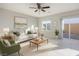 Bright living room with a sliding door to the backyard, neutral colors, and comfortable seating at 9871 Magnus Ct, Las Vegas, NV 89178