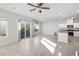 Inviting living area with sliding glass doors to the backyard and an open layout connecting to the kitchen at 9871 Magnus Ct, Las Vegas, NV 89178