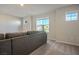 This living room has multiple windows to let in natural light and a gray couch at 9871 Magnus Ct, Las Vegas, NV 89178