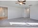 Expansive main bedroom with carpet, a ceiling fan, and an attached bathroom, creating a private oasis at 9871 Magnus Ct, Las Vegas, NV 89178