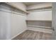 Spacious walk-in closet featuring built-in shelving and neutral carpeting, perfect for organizing clothes and accessories at 9871 Magnus Ct, Las Vegas, NV 89178