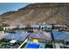 Stunning aerial view of the community with mountain backdrop, showcasing the backyard pool and luxurious homes at 10048 Copper Edge Rd, Las Vegas, NV 89148