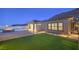 Stylish backyard featuring a fire pit, lush lawn, and access to the home at 10048 Copper Edge Rd, Las Vegas, NV 89148