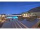 Serene backyard featuring a sparkling pool, comfortable seating areas, and lush desert landscaping, ideal for entertaining at 10048 Copper Edge Rd, Las Vegas, NV 89148