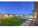 Lush backyard featuring a well-manicured lawn and patio area with a pool at 10048 Copper Edge Rd, Las Vegas, NV 89148