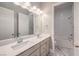 Modern bathroom features a double sink vanity, large mirror, and a separate shower/tub at 10048 Copper Edge Rd, Las Vegas, NV 89148