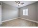 This bedroom offers a ceiling fan, window with blinds, and light wood-look flooring at 10048 Copper Edge Rd, Las Vegas, NV 89148