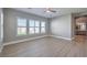 Bright bedroom with large windows, ceiling fan, and wood-look floors at 10048 Copper Edge Rd, Las Vegas, NV 89148