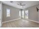 Bright bedroom features hardwood floors, ample natural light, and a ceiling fan at 10048 Copper Edge Rd, Las Vegas, NV 89148