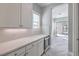 Stylish butler's pantry with sleek countertops, custom cabinets, and a convenient beverage cooler at 10048 Copper Edge Rd, Las Vegas, NV 89148