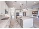 Open-concept kitchen with a large island, stainless appliances, and direct view into the living room at 10048 Copper Edge Rd, Las Vegas, NV 89148