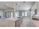 Modern kitchen featuring a large island, updated appliances, and sliding glass doors to the backyard at 10048 Copper Edge Rd, Las Vegas, NV 89148