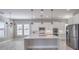 Bright kitchen featuring white cabinets, stainless steel appliances, and a large central island at 10048 Copper Edge Rd, Las Vegas, NV 89148