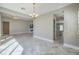 Open living room with herringbone floors, modern lighting, and neutral walls at 10048 Copper Edge Rd, Las Vegas, NV 89148