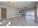 Open living room with herringbone floors, fireplace, and sliding doors to the pool at 10048 Copper Edge Rd, Las Vegas, NV 89148