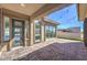 Cozy outdoor living space with a brick patio, covered area, and seamless indoor-outdoor transition for relaxation at 10048 Copper Edge Rd, Las Vegas, NV 89148