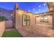 Covered patio with brick flooring, string lights, and mountain views at 10048 Copper Edge Rd, Las Vegas, NV 89148