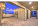 Covered patio has brick flooring, tasteful lighting, and manicured landscaping at 10048 Copper Edge Rd, Las Vegas, NV 89148