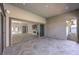 Covered patio with tile flooring looking into the home's living area and backyard at 10048 Copper Edge Rd, Las Vegas, NV 89148