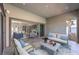 Comfortable covered patio with neutral-colored seating and sliding doors leading into the spacious interior at 10048 Copper Edge Rd, Las Vegas, NV 89148
