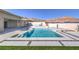 A luxurious pool and spa are surrounded by modern landscaping, perfect for relaxation at 10048 Copper Edge Rd, Las Vegas, NV 89148