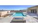 A luxurious pool and spa are surrounded by modern landscaping, perfect for relaxation at 10048 Copper Edge Rd, Las Vegas, NV 89148