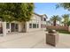 Spacious backyard features concrete patio, grill station, and privacy wall with palm trees beyond at 10501 Haywood Dr, Las Vegas, NV 89135