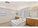 Primary bathroom boasts dual sinks, large tub, and tile flooring at 10501 Haywood Dr, Las Vegas, NV 89135