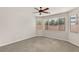 Cozy bedroom with carpet floors, ceiling fan and three large windows at 10501 Haywood Dr, Las Vegas, NV 89135