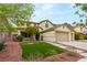 Charming two-story home with lush lawn and neatly arranged garden beds at 10501 Haywood Dr, Las Vegas, NV 89135