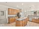 Bright kitchen features tile flooring, stainless steel appliances, light wood cabinetry and a center island at 10501 Haywood Dr, Las Vegas, NV 89135