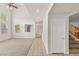 Bright and airy living room features vaulted ceiling and staircase to the upper level at 10501 Haywood Dr, Las Vegas, NV 89135