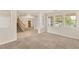 Cozy living room with plush carpeting and large windows providing natural light at 10501 Haywood Dr, Las Vegas, NV 89135