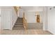 Welcoming living area with plush carpeting and staircase access to the upper floor at 10501 Haywood Dr, Las Vegas, NV 89135