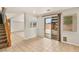 Open-concept living room boasts tile flooring, sliding glass door to patio, and stairway at 10501 Haywood Dr, Las Vegas, NV 89135