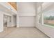 Bright living room with carpet flooring, large windows and view of the second story at 10501 Haywood Dr, Las Vegas, NV 89135