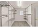 Walk-in closet features metal racks and shelves with carpeted flooring and a small window at 10501 Haywood Dr, Las Vegas, NV 89135