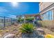 Desert landscaped backyard with covered patio and metal fence to enjoy the beautiful outdoor living at 10633 Tinta Ln, Las Vegas, NV 89144