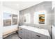 Modern bathroom featuring double sinks, marble counters, and tiled walls at 10633 Tinta Ln, Las Vegas, NV 89144