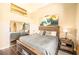 Well-lit bedroom featuring neutral colors, decorative surfboard and ensuite bathroom at 10633 Tinta Ln, Las Vegas, NV 89144