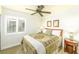 Comfortable bedroom with a ceiling fan and a window offering natural light at 10633 Tinta Ln, Las Vegas, NV 89144