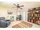 Bright bedroom features a workstation, seating area, ceiling fan and display of cowboy boots at 10633 Tinta Ln, Las Vegas, NV 89144